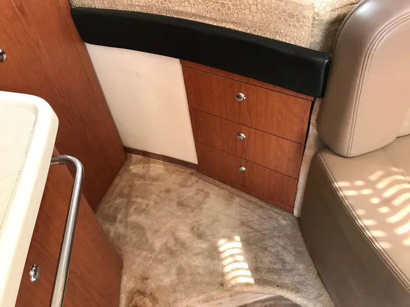 Slide: The Image of Interior of 2002 Chaparral Signature 300 boat with wooden cabinets and beige upholstery. - 36