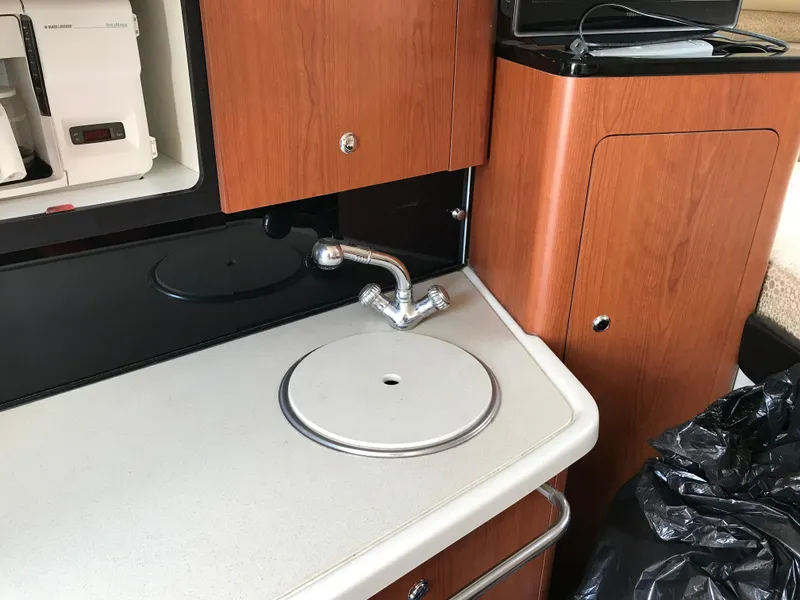 Slide: The Image of 2002 Chaparral Signature 300 boat kitchen sink and countertop area. - 37