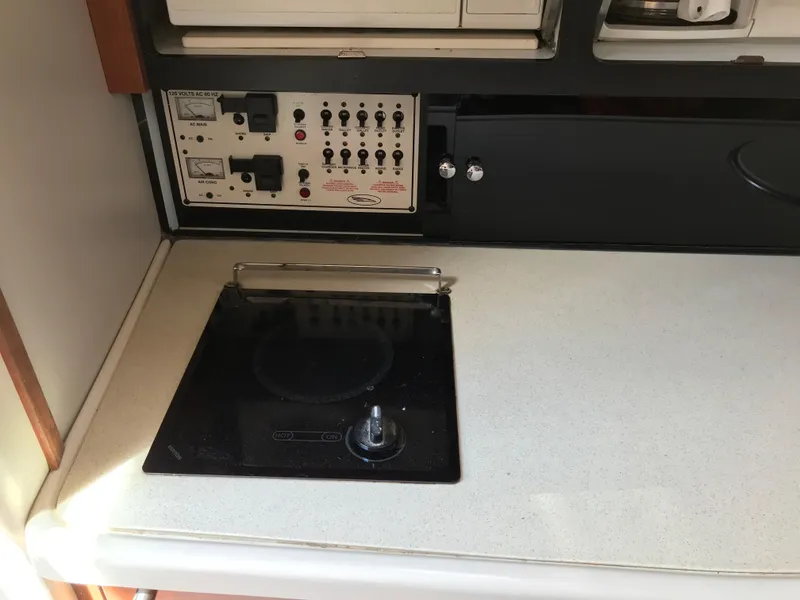 Slide: The Image of 2002 Chaparral Signature 300 boat kitchen with stove and control panel. - 38