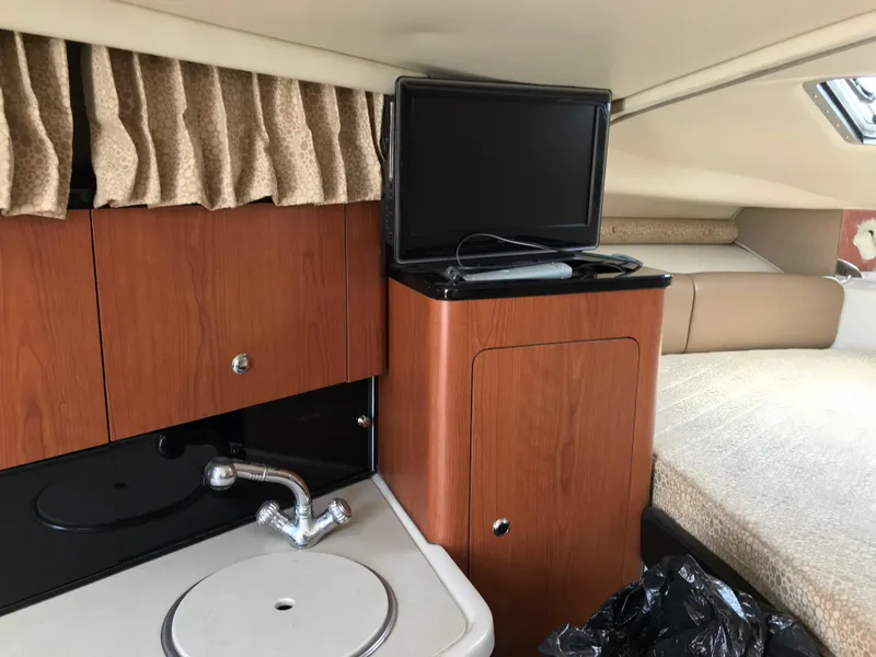 Slide: The Image of Interior of 2002 Chaparral Signature 300 with kitchenette, TV, and bed. - 39