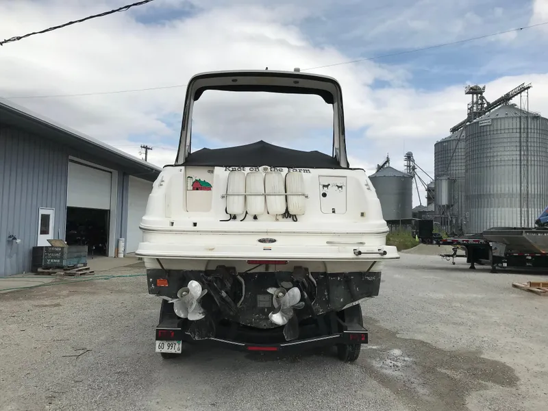 Slide: The Image of 2002 Chaparral Signature 300 boat, rear view, parked near industrial buildings. - 5