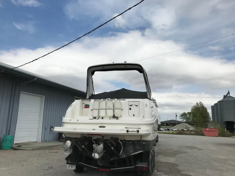 Slide: The Image of 2002 Chaparral Signature 300 boat parked outdoors near a warehouse. - 9