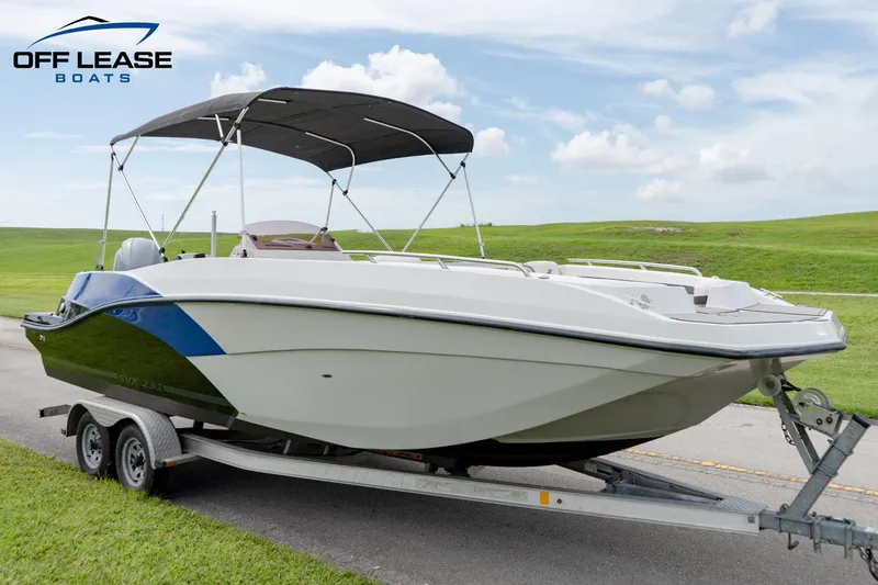 Slide: The Image of 2022 Starcraft SVX 231 OB boat on trailer with bimini top, displayed by Off Lease Boats. - 3