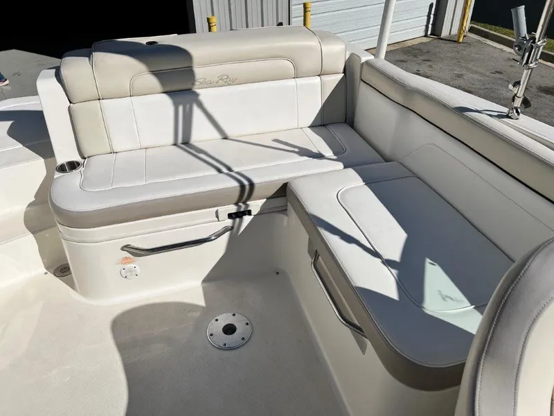 Slide: The Image of 2013 Sea Ray 260 Sundeck interior seating area with white and beige upholstery. - 11