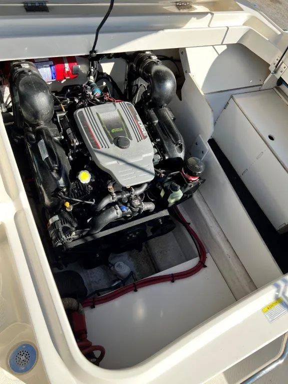 Slide: The Image of 2013 Sea Ray 260 Sundeck engine compartment with visible engine components. - 13