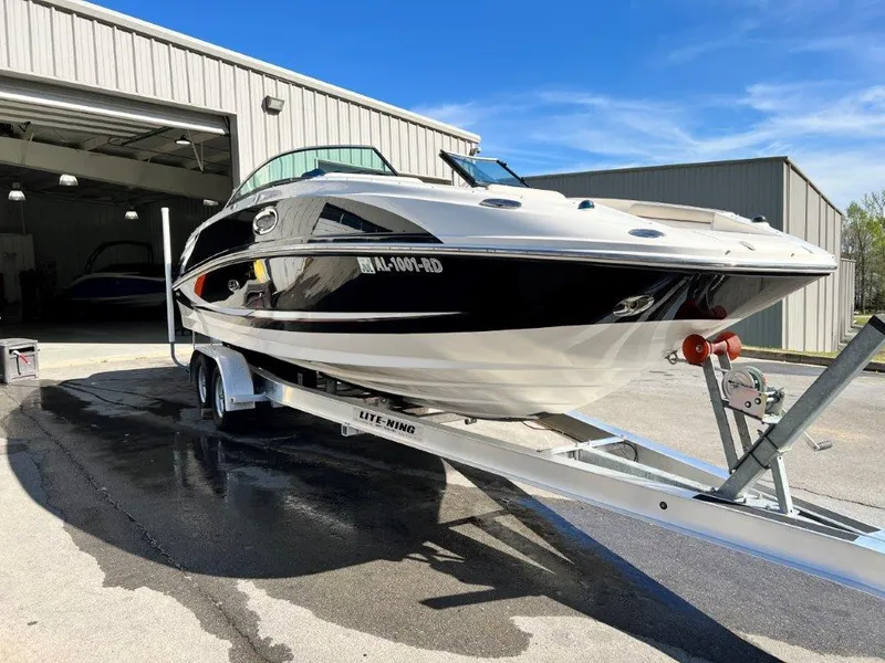 Slide: The Image of 2013 Sea Ray 260 Sundeck boat on trailer outside a storage facility. - 16