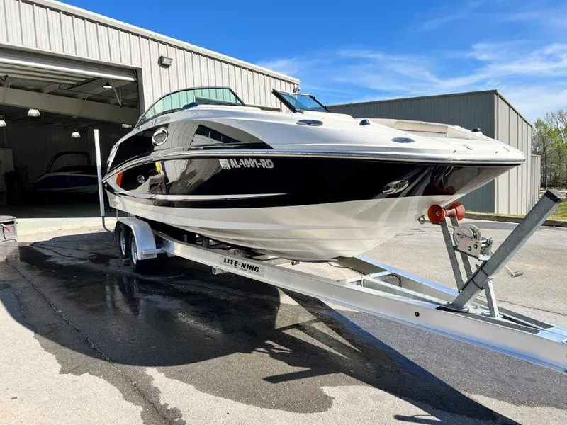 Slide: The Image of 2013 Sea Ray 260 Sundeck boat on trailer outside a storage facility. - 3