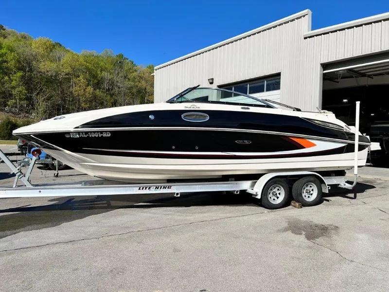 Slide: The Image of 2013 Sea Ray 260 Sundeck boat on trailer outside a warehouse. - 4