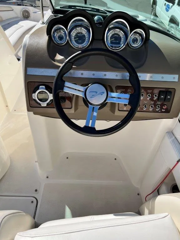 Slide: The Image of 2013 Sea Ray 260 Sundeck boat dashboard with steering wheel and gauges. - 7