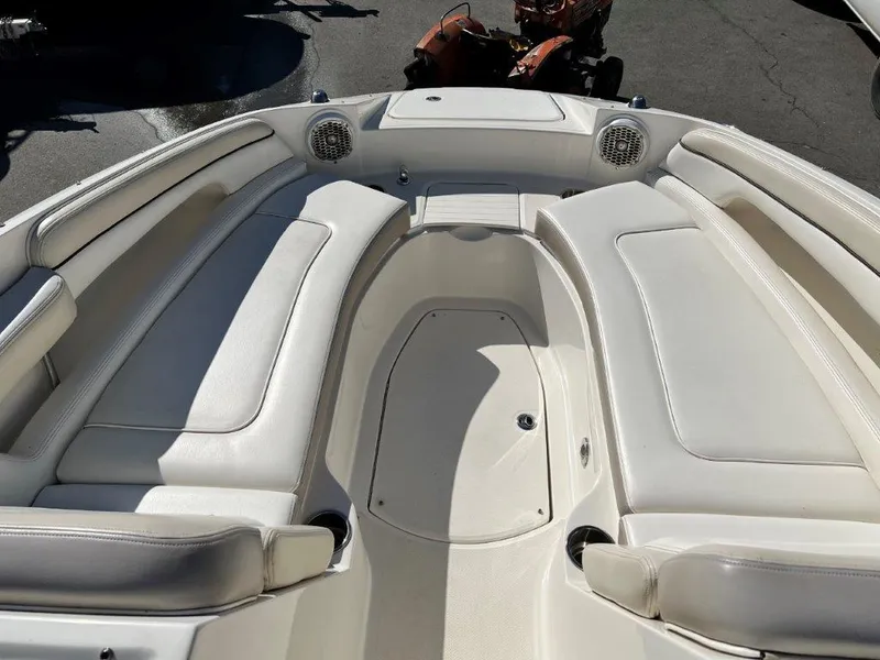 Slide: The Image of 2013 Sea Ray 260 Sundeck boat interior with white cushioned seating. - 8