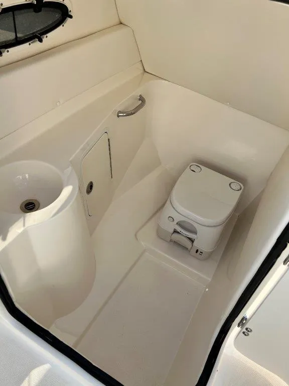 Slide: The Image of 2013 Sea Ray 260 Sundeck boat interior with compact toilet and sink. - 9
