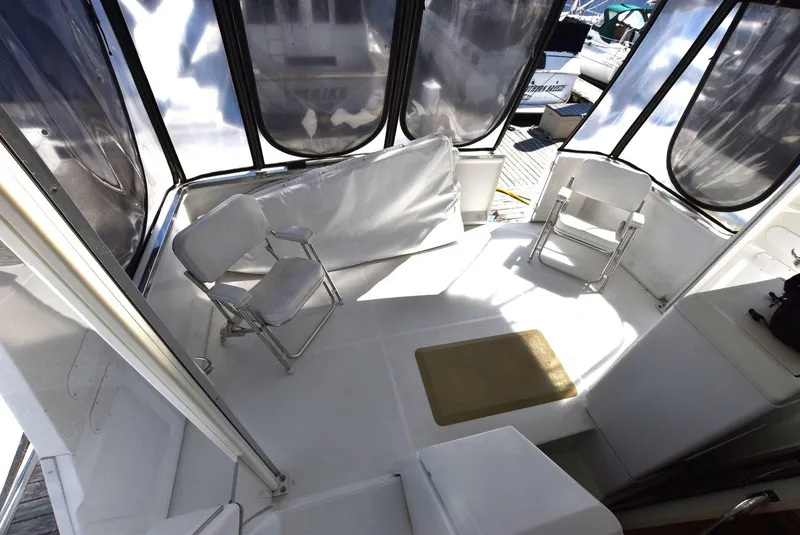Slide: The Image of 1999 Carver 356 Aft Cabin boat interior with seating and enclosed deck. - 6