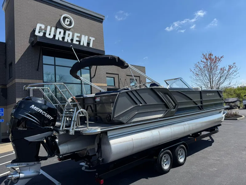 Slide: The Image of 2023 Crest Continental 250 boat on trailer outside dealership, featuring Mercury engine. - 3