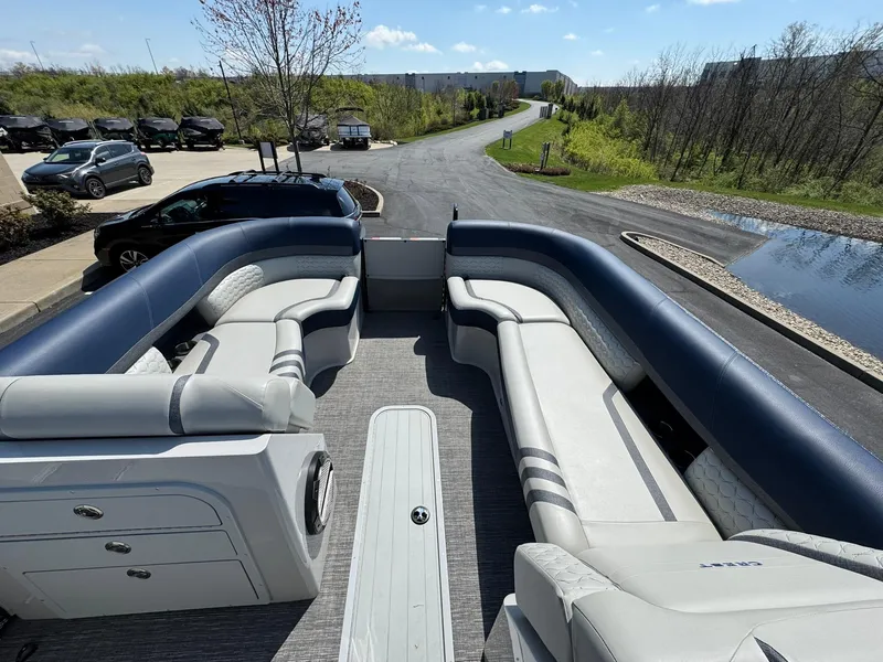 Slide: The Image of 2023 Crest Continental 250 pontoon boat interior with spacious seating and modern design. - 7