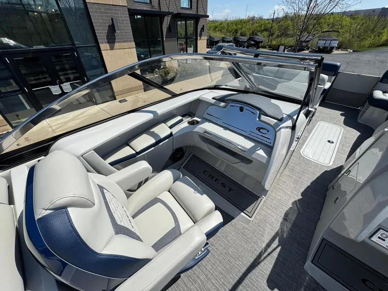 Slide: The Image of 2023 Crest Continental 250 boat interior with modern dashboard and luxurious seating. - 9