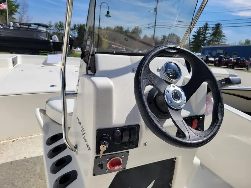 Slide: The Image of 2024 Mako SKIFF 17 CC boat console with steering wheel and control panel. - 10