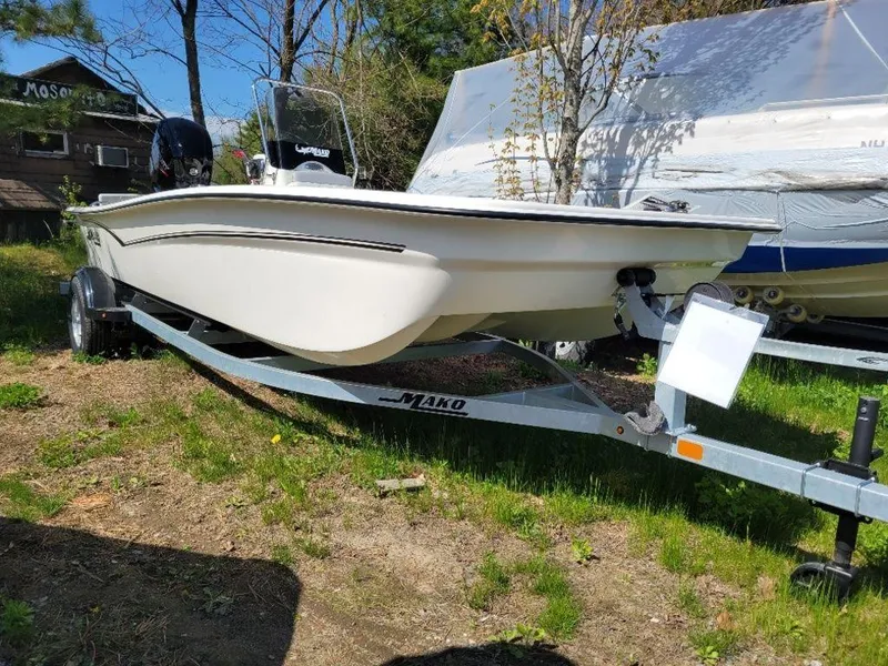 Slide: The Image of 2024 Mako SKIFF 17 CC boat on trailer in outdoor setting. - 3