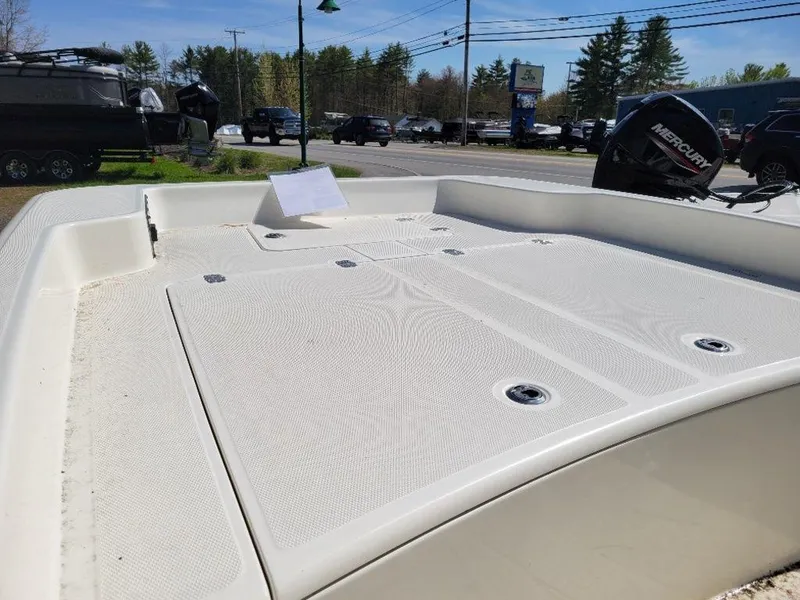 Slide: The Image of 2024 Mako SKIFF 17 CC boat deck with storage compartments and Mercury outboard motor. - 9