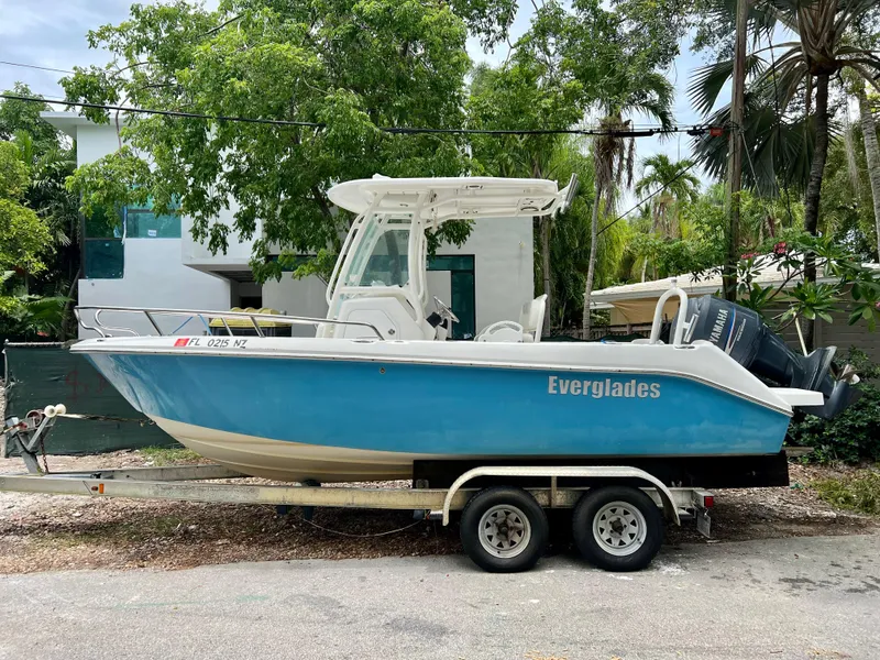 Slide: The Image of 2009 Everglades 210CC boat on a trailer, parked outdoors. - 0