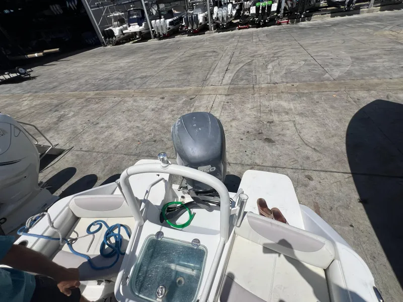 Slide: The Image of 2009 Everglades 210CC boat with outboard motor in a marina. - 11