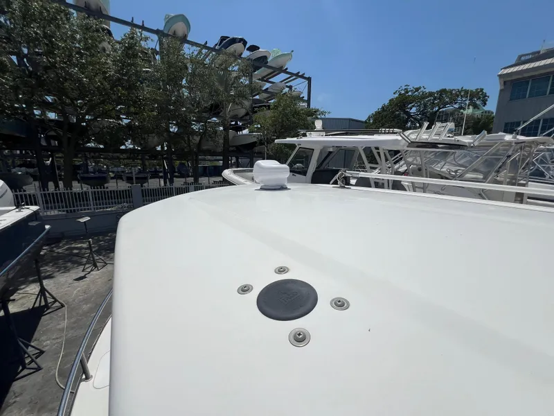 Slide: The Image of 2009 Everglades 210CC boat deck in a marina under clear blue sky. - 12