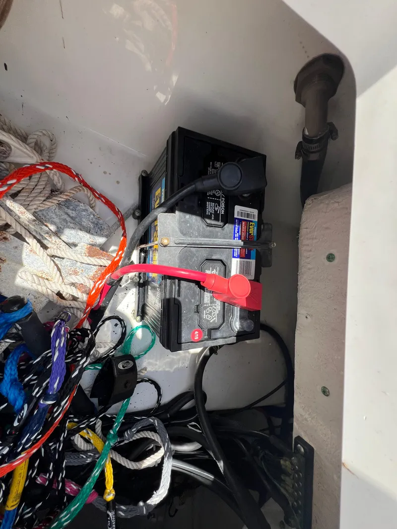 Slide: The Image of Battery compartment of a 2009 Everglades 210CC boat with wiring and ropes. - 17