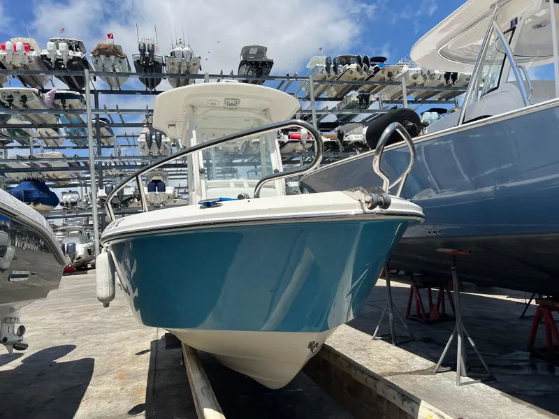 Slide: The Image of 2009 Everglades 210CC boat in storage, blue hull, marina background. - 7