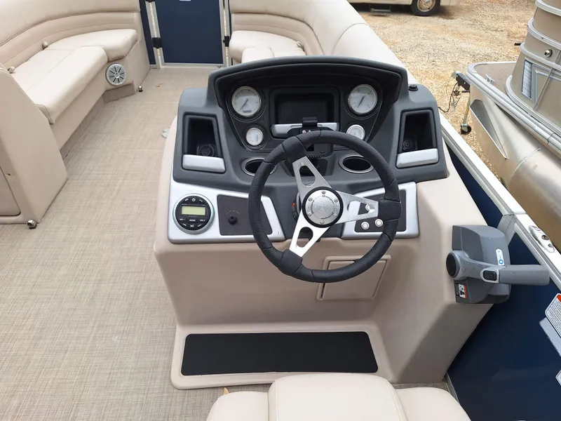Slide: The Image of 2017 Ranger REATA boat interior with steering console and beige seating. - 3