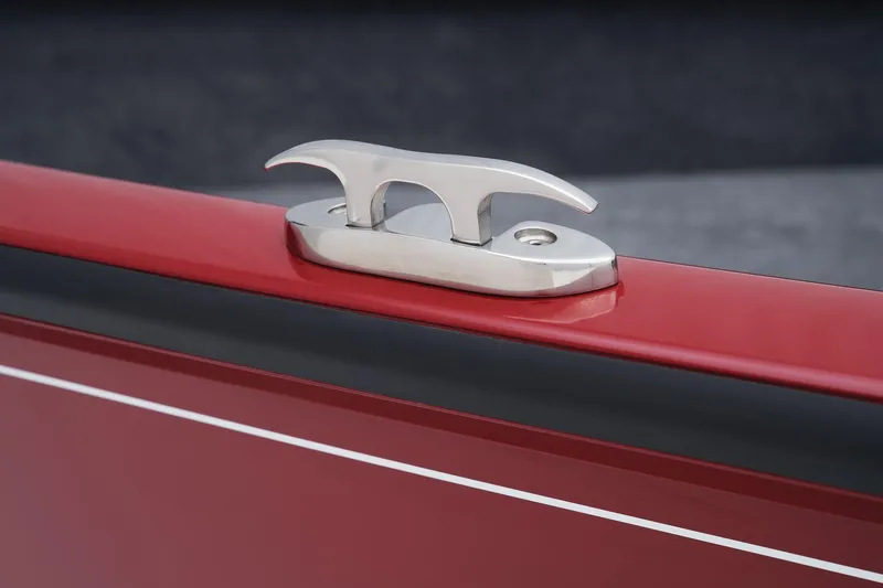 Slide: The Image of Close-up of 2025 Tracker Super Guide V-16 SC boat cleat on red hull. - 21