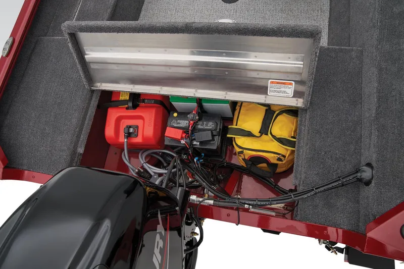 Slide: The Image of 2025 Tracker Super Guide V-16 SC boat storage compartment with battery and fuel tank. - 25