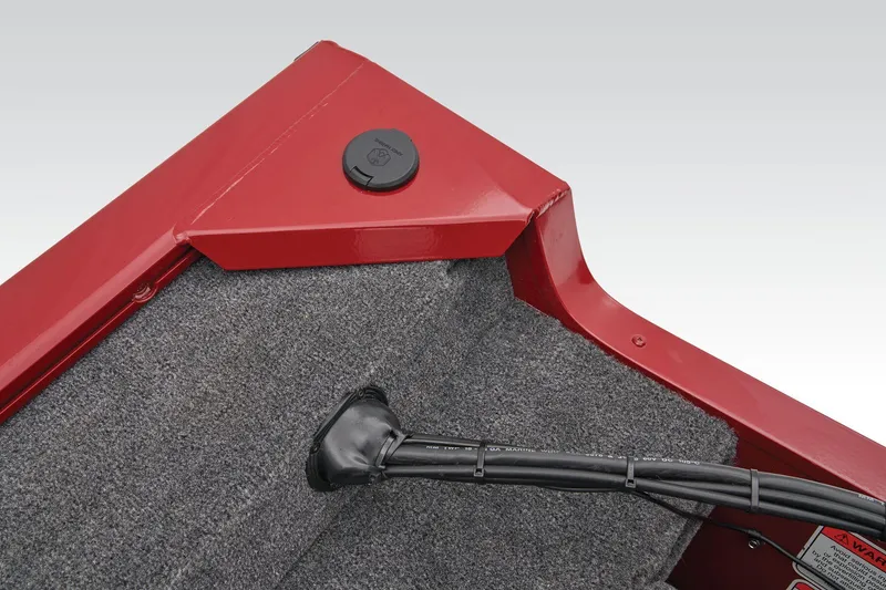 Slide: The Image of 2025 Tracker Super Guide V-16 SC boat interior detail with red trim and carpeted surface. - 26