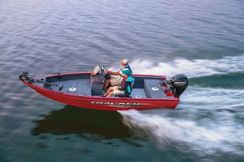 Slide: The Image of 2025 Tracker Super Guide V-16 SC boat speeding on water. - 30