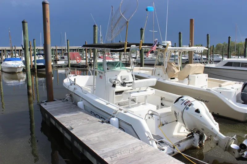 Slide: The Image of 1999 Robalo 2420 Center Console boat docked at a marina. - 0