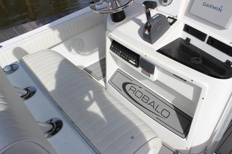 Slide: The Image of 1999 Robalo 2420 Center Console boat interior with steering wheel and seating. - 16