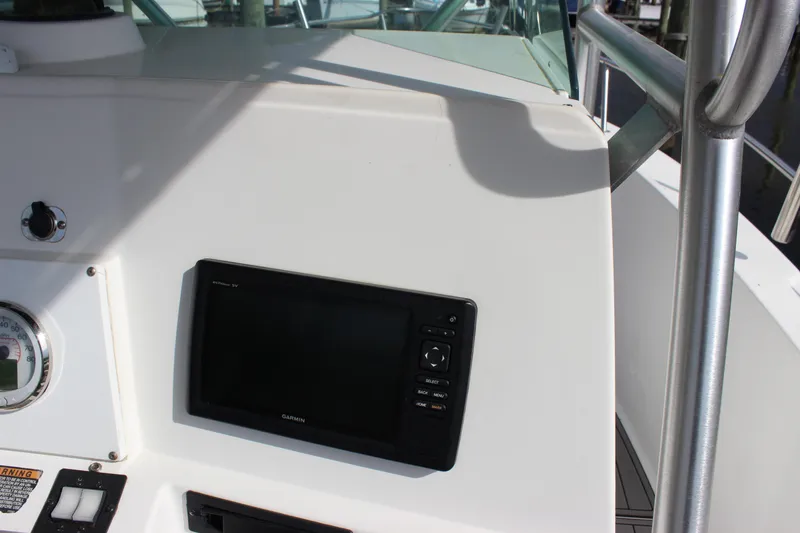 Slide: The Image of 1999 Robalo 2420 Center Console boat dashboard with Garmin display. - 18
