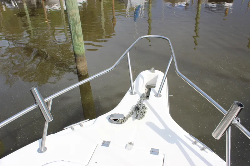 Slide: The Image of Bow of 1999 Robalo 2420 Center Console boat with anchor and railings. - 6