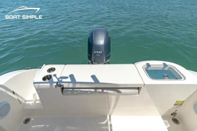 Slide: The Image of 2021 Cobia 201 Center Console boat with Yamaha 150 engine on calm water. - 9