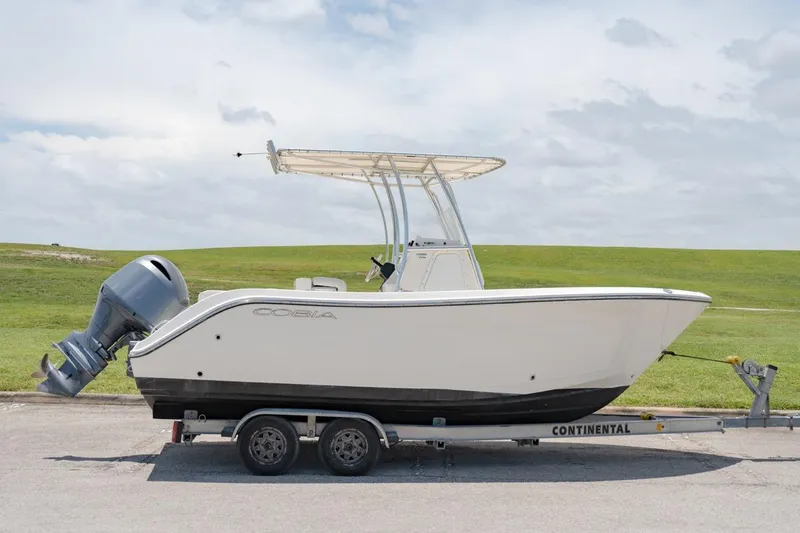 Slide: The Image of 2021 Cobia 201 Center Console boat on a Continental trailer. - 2
