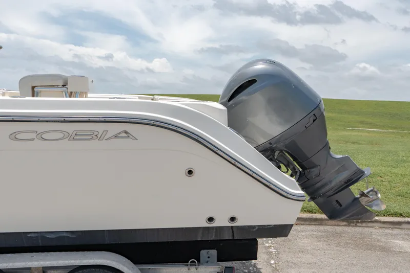 Slide: The Image of 2021 Cobia 201 Center Console boat with outboard motor on trailer. - 6