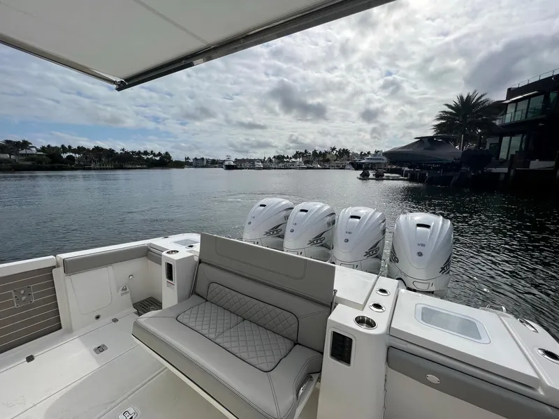 Slide: The Image of 2022 Pursuit S 428 Sport boat with quad engines docked in a scenic marina. - 12