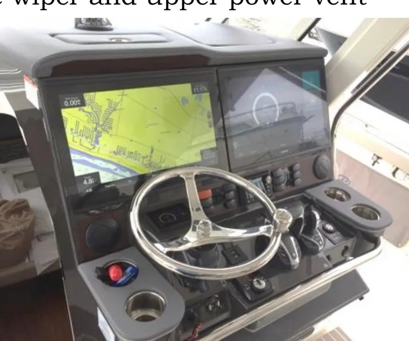 Slide: The Image of 2022 Pursuit S 428 Sport boat helm with dual navigation screens and steering wheel. - 13