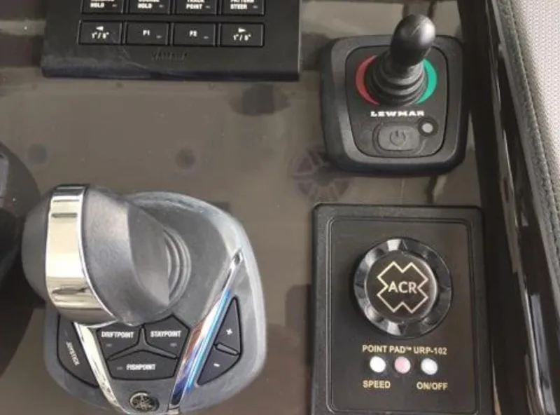 Slide: The Image of Control panel of a 2022 Pursuit S 428 Sport boat with joystick and throttle. - 16