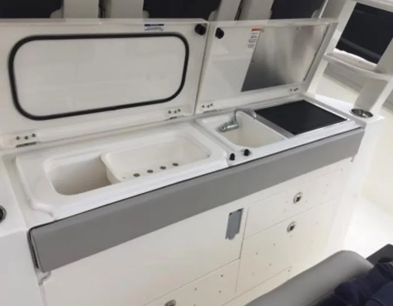 Slide: The Image of 2022 Pursuit S 428 Sport boat galley with sink, storage, and prep area. - 20