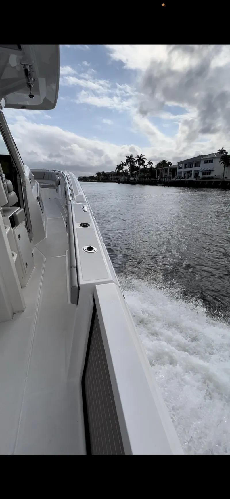 Slide: The Image of 2022 Pursuit S 428 Sport boat cruising on a scenic waterway. - 7