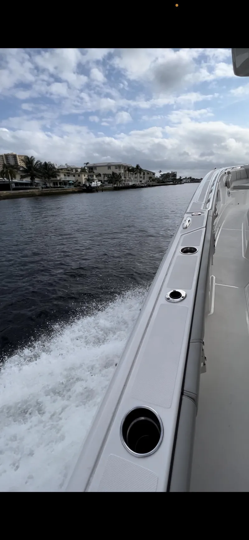 Slide: The Image of 2022 Pursuit S 428 Sport boat cruising on a calm waterway. - 8