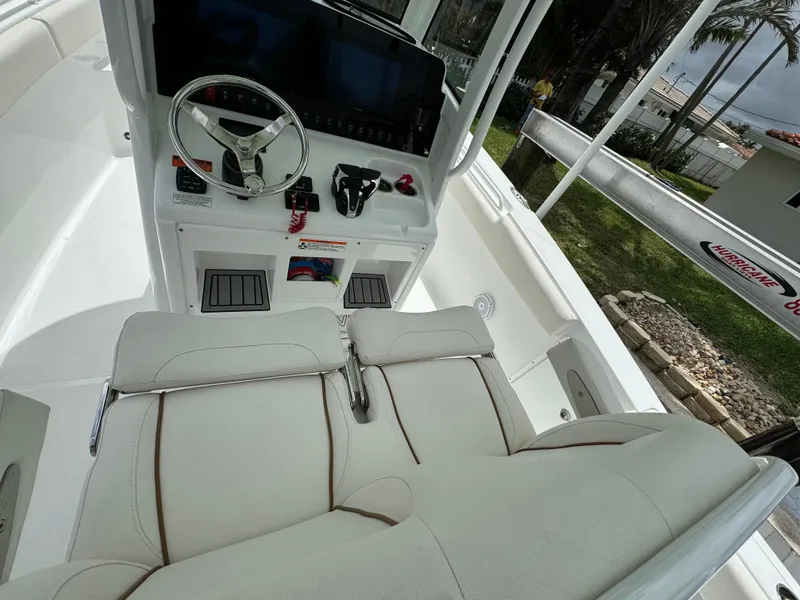 Slide: The Image of 2022 Sea Hunt 27 Gamefish boat cockpit with steering wheel and seating. - 10