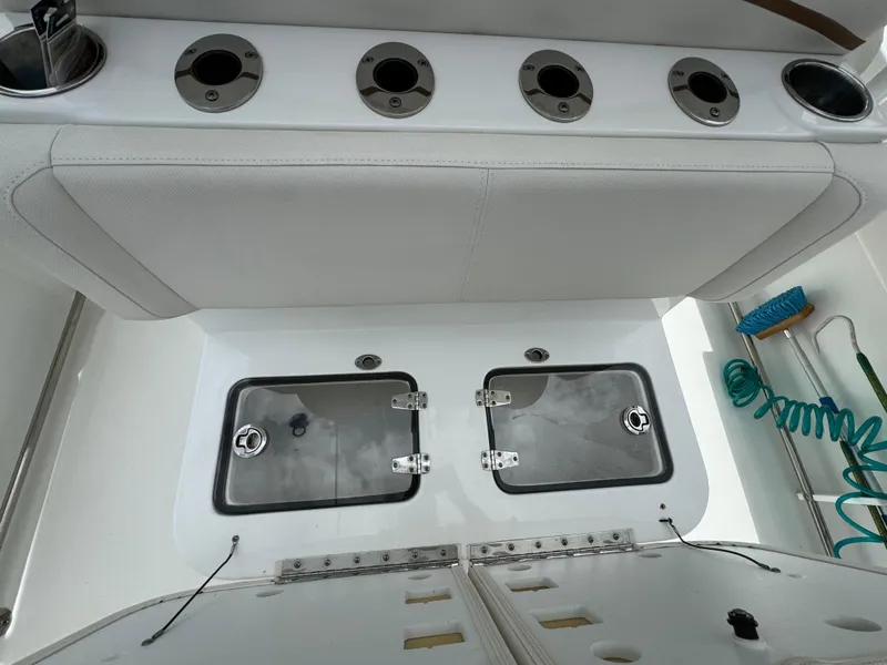 Slide: The Image of 2022 Sea Hunt 27 Gamefish boat with rod holders and storage compartments. - 14