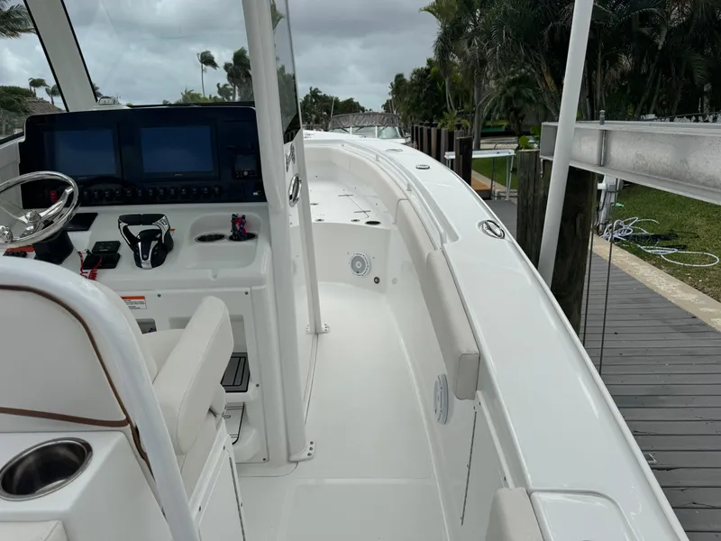 Slide: The Image of 2022 Sea Hunt 27 Gamefish boat interior with helm and seating. - 17