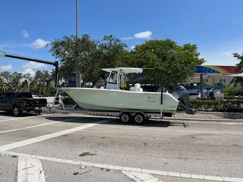 Slide: The Image of 2022 Sea Hunt 27 Gamefish boat on a trailer at an intersection. - 4
