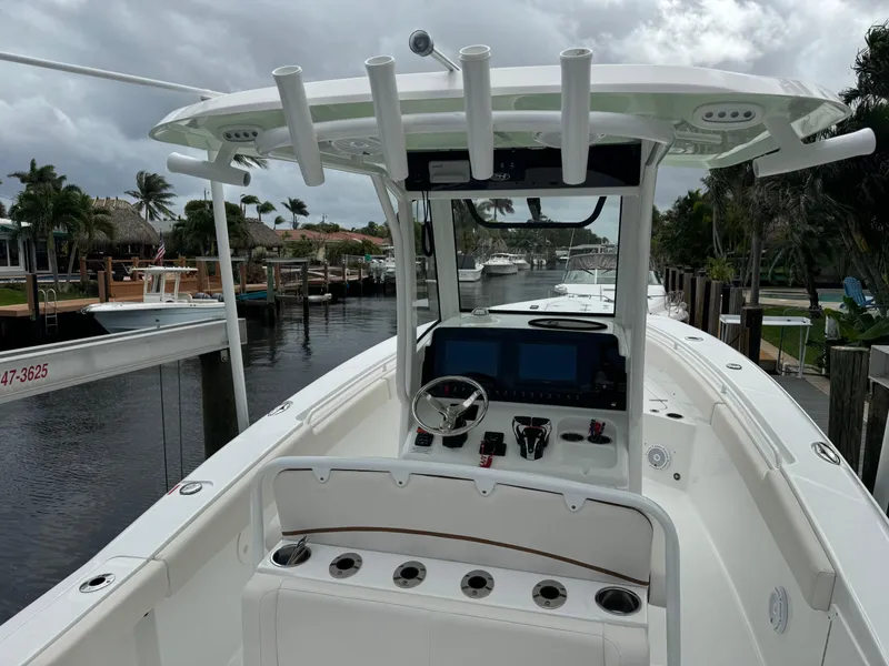 Slide: The Image of 2022 Sea Hunt 27 Gamefish boat docked in a marina, featuring a modern helm station. - 6